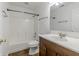 A clean and simple bathroom features a shower-tub combo and a wooden vanity with white countertops at 14117 Princewood Dr, Fishers, IN 46037