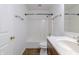 A clean and simple bathroom features a shower-tub combo and a wooden vanity with white countertops at 14117 Princewood Dr, Fishers, IN 46037