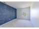 A bedroom features a unique navy blue wall with a constellation design and a window for natural light at 14117 Princewood Dr, Fishers, IN 46037