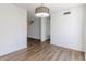 Bright dining area features modern light fixture and new wood-look flooring at 14117 Princewood Dr, Fishers, IN 46037