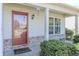 Charming front porch with a red door and lovely landscaping, inviting and welcoming at 14117 Princewood Dr, Fishers, IN 46037