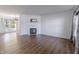 Open-concept living room with hardwood floors, fireplace, and access to dining area, great for entertaining at 14117 Princewood Dr, Fishers, IN 46037
