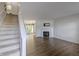 Inviting living room with a fireplace, hardwood floors, and an open staircase, perfect for gatherings at 14117 Princewood Dr, Fishers, IN 46037