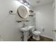 Updated powder room with modern vanity, mirror, and floating shelves at 14117 Princewood Dr, Fishers, IN 46037
