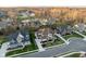 An aerial view of a lovely suburban neighborhood, showcasing meticulously manicured lawns and a pond at 14872 Autumn View Way, Fishers, IN 46037