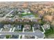 Aerial view of a community featuring homes with manicured lawns and a serene pond at 14872 Autumn View Way, Fishers, IN 46037