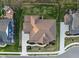 A bird's-eye view of a home with a manicured lawn, deck, and lush garden at 14872 Autumn View Way, Fishers, IN 46037