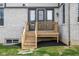 Backyard features a small deck, lush green grass, and a well-maintained lawn with a brick facade at 14872 Autumn View Way, Fishers, IN 46037