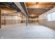Spacious unfinished basement with concrete foundation and exposed ceiling offering potential for customization and ample storage at 14872 Autumn View Way, Fishers, IN 46037