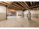 Unfinished basement with concrete floor, exposed beams, utilities, and white-wrapped walls, offering potential for customization at 14872 Autumn View Way, Fishers, IN 46037