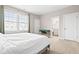 Bright bedroom featuring a comfortable bed, neutral walls, and access to bathroom at 14872 Autumn View Way, Fishers, IN 46037