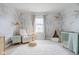 Bright Bedroom with wallpaper, a crib, a reading chair, and a play tent at 14872 Autumn View Way, Fishers, IN 46037