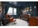 Stylish Bedroom with dark walls, a crib, a leather chair, and charming decor at 14872 Autumn View Way, Fishers, IN 46037
