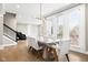 Bright dining room with a stone table and a view of the staircase and outdoor scenery at 14872 Autumn View Way, Fishers, IN 46037
