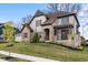 Attractive two-story home featuring a stone and brick facade, complemented by a green lawn and landscaping at 14872 Autumn View Way, Fishers, IN 46037
