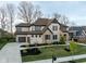 Beautiful two-story home with a stone and brick facade, lush landscaping, and a spacious driveway at 14872 Autumn View Way, Fishers, IN 46037