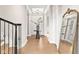 Elegant foyer with hardwood floors, white columns, and a view of the front door at 14872 Autumn View Way, Fishers, IN 46037