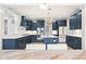 Stunning blue kitchen with white countertops, tiled backsplash, and modern lighting fixtures at 14872 Autumn View Way, Fishers, IN 46037