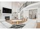Comfortable living room with a fireplace, staircase, and cozy seating arrangement at 14872 Autumn View Way, Fishers, IN 46037