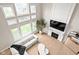 Sunlit living room with a modern fireplace, television, and a cozy seating arrangement at 14872 Autumn View Way, Fishers, IN 46037