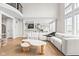 Open-concept living room featuring high ceilings, a modern sofa, and a view into the kitchen at 14872 Autumn View Way, Fishers, IN 46037
