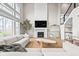 Bright and spacious living room with a fireplace, large windows, and stylish modern decor at 14872 Autumn View Way, Fishers, IN 46037