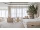 Elegant main bedroom featuring a seating area, tray ceiling, and large windows with sheer curtains at 14872 Autumn View Way, Fishers, IN 46037
