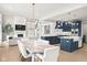 Open concept home with a living room fireplace, dining area with marble table, and island kitchen at 14872 Autumn View Way, Fishers, IN 46037