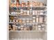 Organized pantry shelves stocked with various food items in clear containers at 14872 Autumn View Way, Fishers, IN 46037