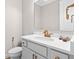 Elegant powder room featuring white vanity with gold fixtures and a sleek toilet at 14872 Autumn View Way, Fishers, IN 46037