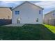 Home exterior displaying a back patio and a large grassy lawn perfect for outdoor activities and relaxation at 15507 Dry Creek Rd, Noblesville, IN 46060