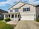 Charming two-story home featuring a covered porch, attached two-car garage, and well-maintained lawn at 15507 Dry Creek Rd, Noblesville, IN 46060