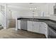 Modern kitchen with stainless steel appliances, white cabinets, and dark countertops at 15507 Dry Creek Rd, Noblesville, IN 46060