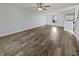 Bright, open-concept living room features wood floors and a ceiling fan at 15507 Dry Creek Rd, Noblesville, IN 46060