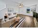 Bright living room with hardwood floors, a ceiling fan, a neutral color palette, and stylish decor at 15507 Dry Creek Rd, Noblesville, IN 46060