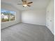 Bright main bedroom with neutral carpet, a ceiling fan and large window at 15507 Dry Creek Rd, Noblesville, IN 46060