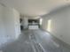 Unfinished kitchen and living area with an island, dark brown cabinets, and plenty of natural light at 1656 Winn Ct, Fortville, IN 46040