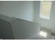 A clean stairway with white walls and railings, leading to the upper floor of the home with natural light at 1656 Winn Ct, Fortville, IN 46040