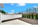 View of backyard with a vinyl fence, black aluminum fence, small garden, and concrete patio at 16870 Imperial Ct, Fishers, IN 46040
