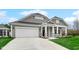 Charming home with a gray exterior, a white garage door, and a well-manicured lawn at 16870 Imperial Ct, Fishers, IN 46040