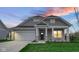 Charming single-Gathering home with inviting entrance, stone accents, lush lawn, and attached garage at 16870 Imperial Ct, Fishers, IN 46040