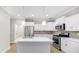 Well-lit kitchen with white cabinets, stainless steel appliances, and a functional island at 16870 Imperial Ct, Fishers, IN 46040