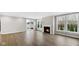 Spacious living room with wood flooring, a cozy fireplace, and a sliding door to the backyard at 16870 Imperial Ct, Fishers, IN 46040