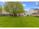 Expansive backyard with mature trees, a well-manicured lawn, and an inviting patio at 17072 Newberry Ln, Westfield, IN 46074
