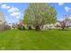 Lush backyard with a sprawling lawn and mature trees, offering a private retreat at 17072 Newberry Ln, Westfield, IN 46074