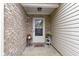 Inviting front porch, with beautiful brick and vinyl siding, decorated with plants and a decorative wreath at 17072 Newberry Ln, Westfield, IN 46074