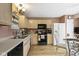 Functional kitchen area featuring wood cabinets, modern appliances, and a breakfast table, all bathed in natural light at 17072 Newberry Ln, Westfield, IN 46074