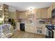 The kitchen boasts tan cabinets, black appliances, and an eat-in dining area with ample counter space at 17072 Newberry Ln, Westfield, IN 46074