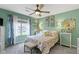 A relaxing bedroom with a floral bedding, a ceiling fan, and calming light-green colored walls at 17072 Newberry Ln, Westfield, IN 46074