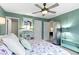 A relaxing bedroom with light-green walls, floral bedding, ceiling fan, and inviting decor at 17072 Newberry Ln, Westfield, IN 46074